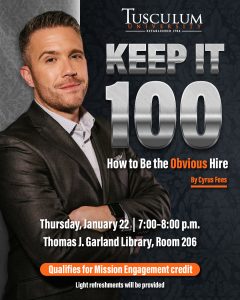 Man featured with arms across his chest, wearing a dark suit